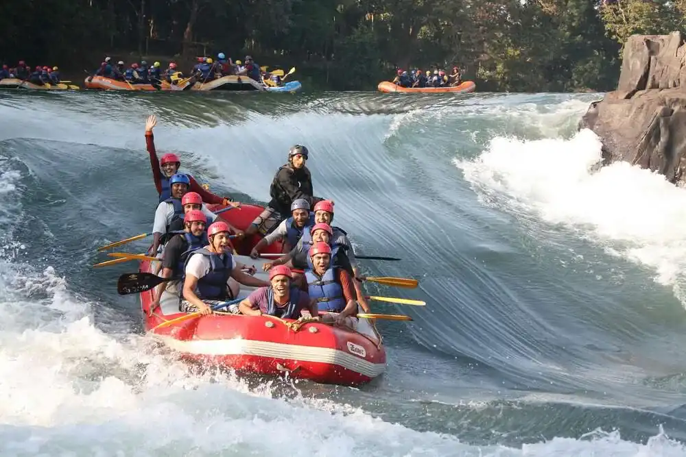 Adventurers enjoying surf boating on the rushing waters of Kali River Dandeli