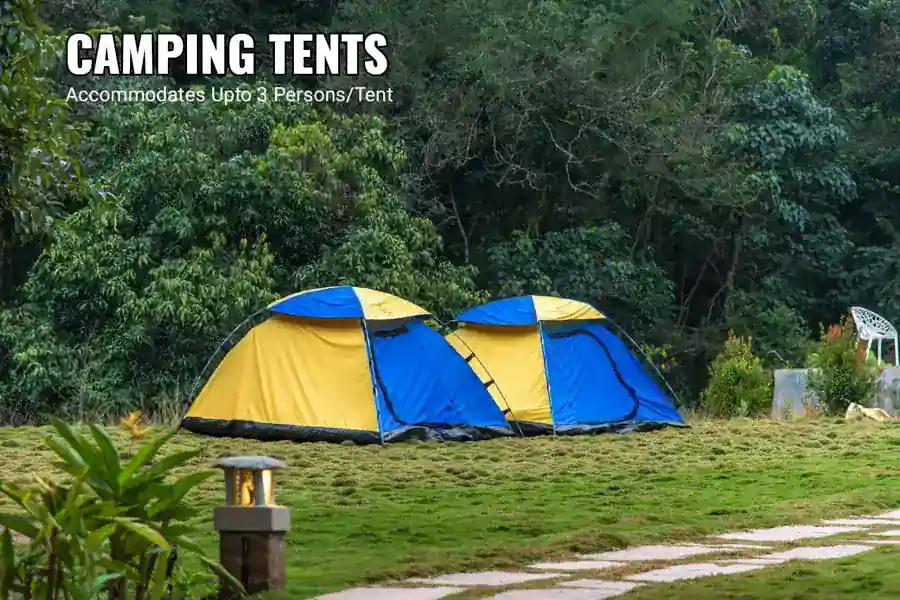 Adventure camping tents set in garden area at Tusker Trails