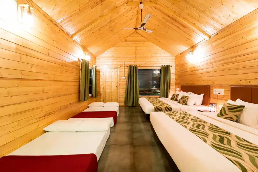 Rustic wooden cottage exterior blending with nature at Tusker Trails